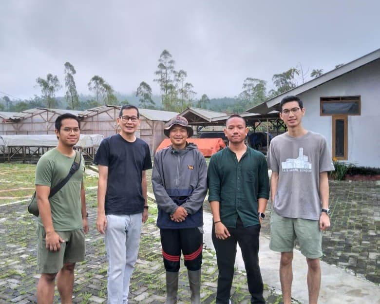 Group of people in coffee field
